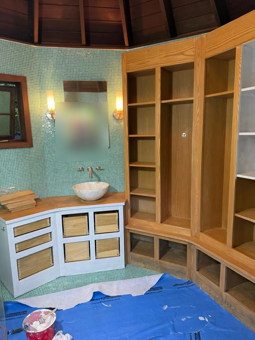 Oak bathroom built-in shelving and vanity before painting