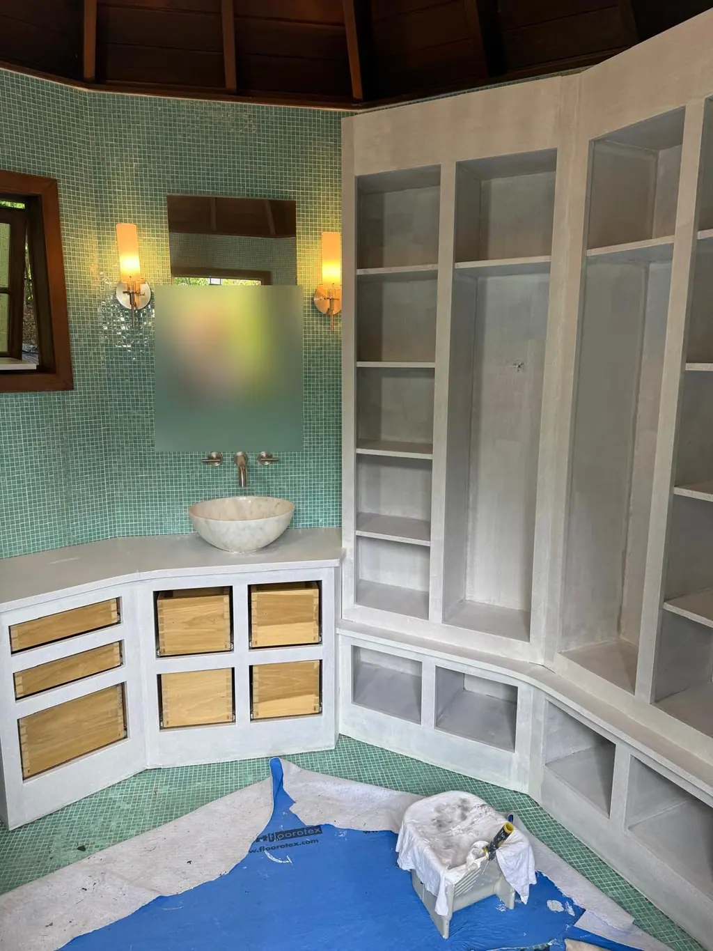 The same bathroom built-in shelving painted white