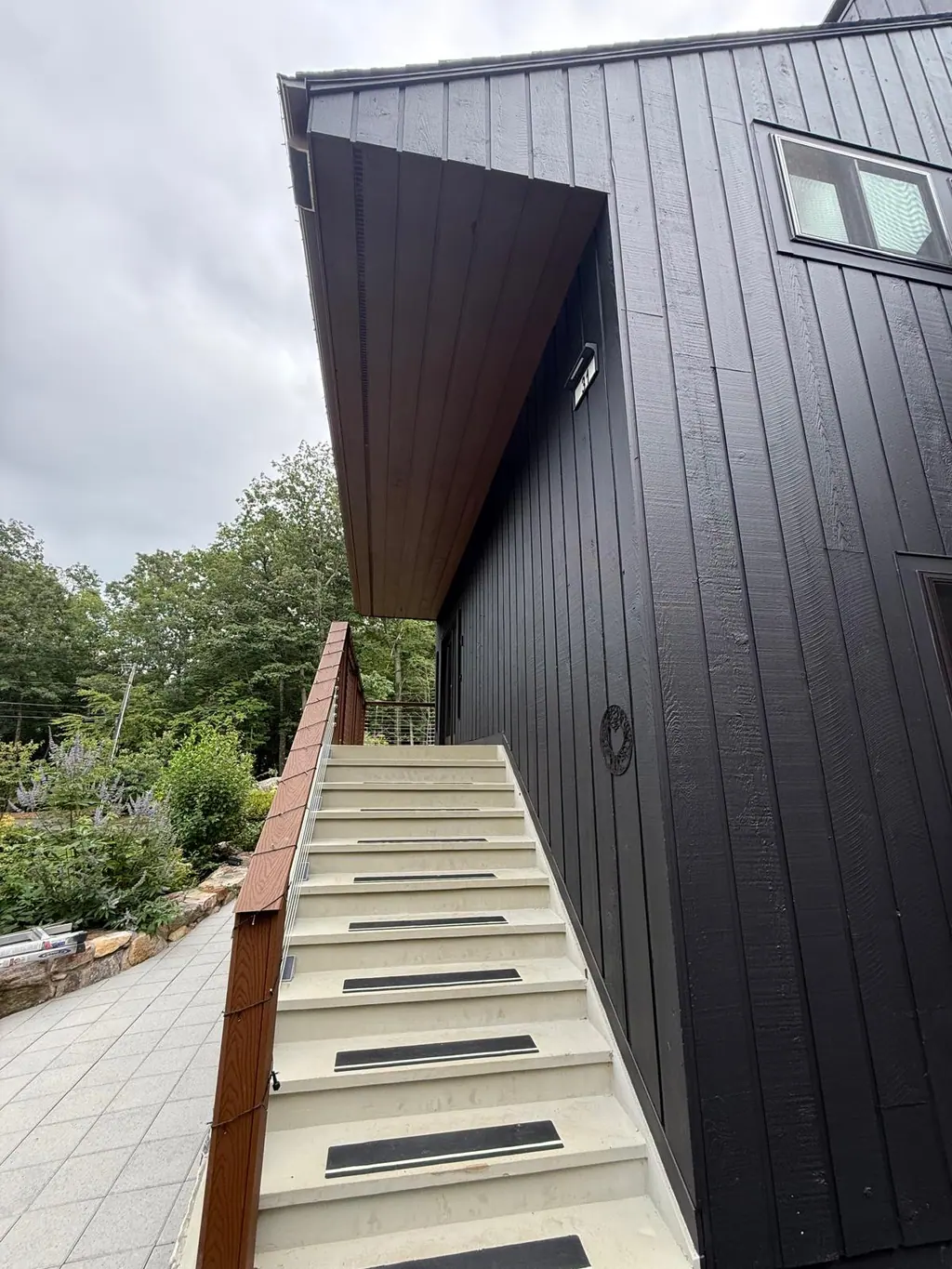 Exterior stairway along a black painted wall