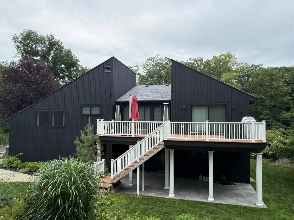 The same back elevation painted black with a white deck railing